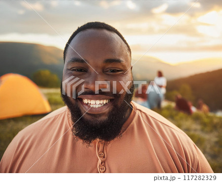 Smiling Man Enjoying Serene Camping Spot 117282329