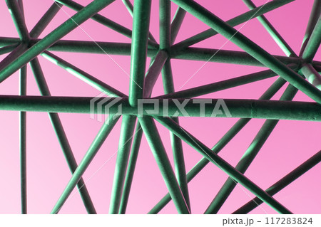 Abstract metal figure on a colorful pink background, artistically welded metal pipes, fragment of scaffolding in NYC 117283824