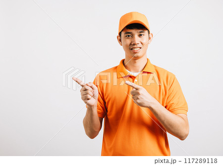 Portrait Asian smiling young delivery man points something with empty space hands studio isolated white background, Happy lifestyle men carry person in an orange shirt uniform happy and positive mood Portrait Asian smiling young delivery man points something with empty space hands studio isolated white background, Happy lifestyle men carry person in an orange shirt uniform happy and positive mood 117289118