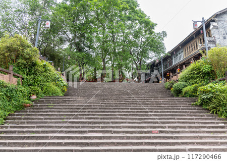 Steps leading to trraditional bodhi wishing tree at Huanglongxi old ancient town is popular tourism landmark in SIchuan, China. Steps leading to trraditional bodhi wishing tree at Huanglongxi old ancient town is popular tourism landmark in SIchuan, China. 117290466