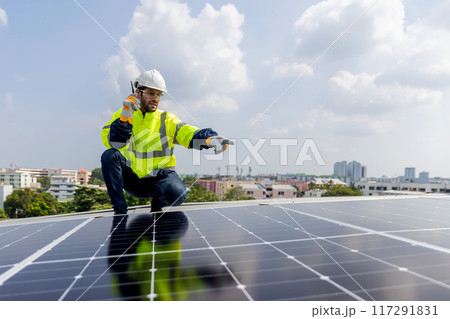 Engineer service check installation solar cell on the roof of factory Engineer service check installation solar cell on the roof of factory 117291831