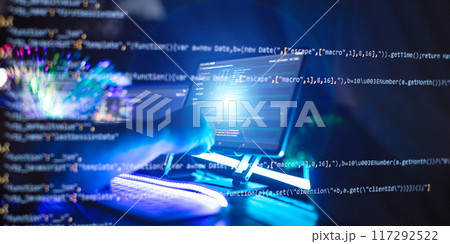 Programmer manually working with program code on a computer at night in a data center Programmer manually working with program code on a computer at night in a data center 117292522