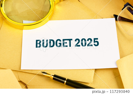 Conceptual budget 2025 symbol. Copy space. Budget 2025 words written on a white business card lying on postal envelopes Conceptual budget 2025 symbol. Copy space. Budget 2025 words written on a white business card lying on postal envelopes 117293840