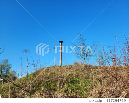 A long thin pipe on the roof of the dugout against the blue sky on a clear spring day 117294769