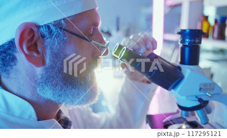 A chemist diligently analyzes samples with advanced equipment in a vibrant laboratory environment. 117295121