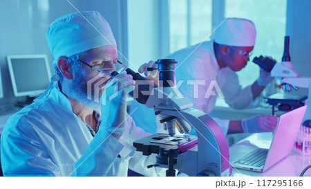 Chemists conduct experiments using advanced equipment to analyze chemical properties in a laboratory setting. Chemists conduct experiments using advanced equipment to analyze chemical properties in a laboratory setting. 117295166