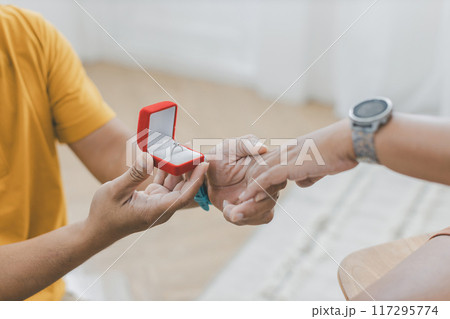 man making a proposal while giving an engagement ring 117295774
