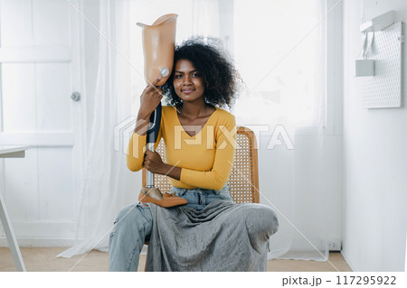 Woman hug prosthetic leg livingroom. applying leg prosthetic concept Woman hug prosthetic leg livingroom. applying leg prosthetic concept 117295922