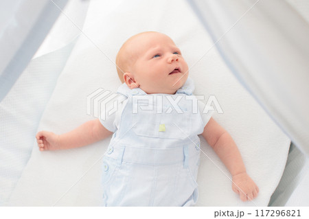 Little baby on white bed 117296821