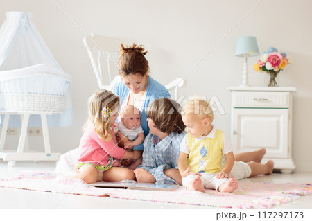 Family with kids playing with newborn baby Family with kids playing with newborn baby 117297173