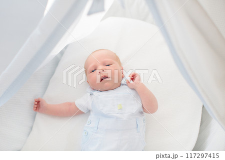 Little baby on white bed Little baby on white bed 117297415