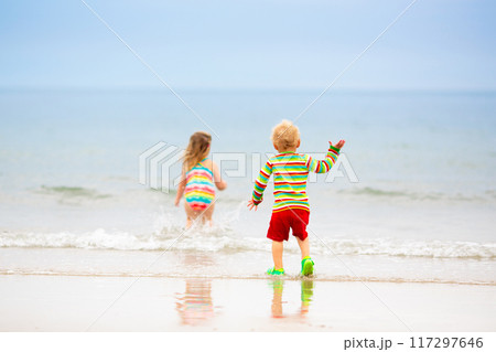 Kids playing on beach. Children play at sea. 117297646