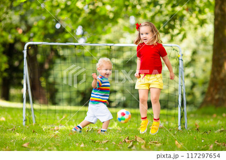 Child playing football. Kids play soccer. 117297654