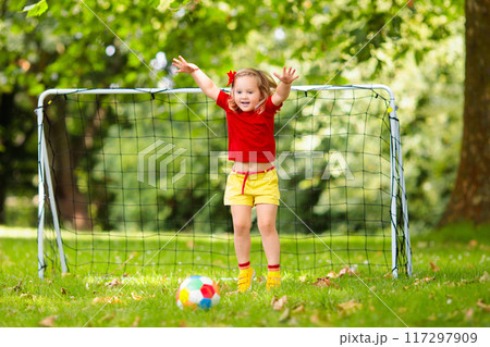 Child playing football. Kids play soccer. 117297909