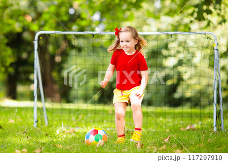 Child playing football. Kids play soccer. Child playing football. Kids play soccer. 117297910