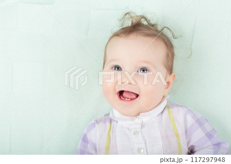 Little baby on white bed 117297948
