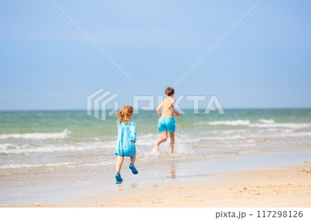 Kids playing on beach. Children play at sea. 117298126