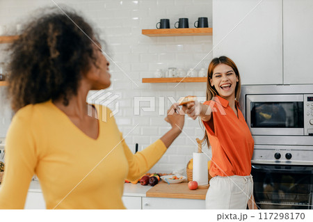 Happy smiling family having fun cooking at kitchen together Happy smiling family having fun cooking at kitchen together 117298170