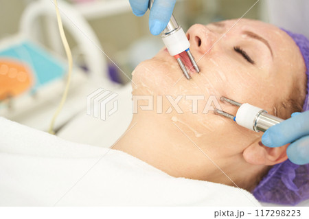 Dermatology anti age treatment. Microcurrent medicine procedure. Woman skin care 117298223