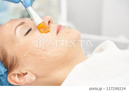 Dermatology anti age treatment. Applying gel with brush. Microcurrent 117298224
