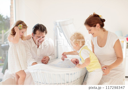Family with kids playing with newborn baby Family with kids playing with newborn baby 117298347