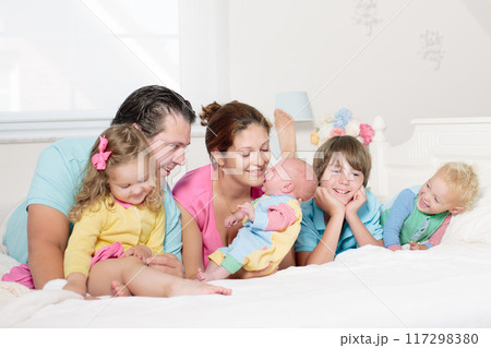 Family with kids playing with newborn baby Family with kids playing with newborn baby 117298380