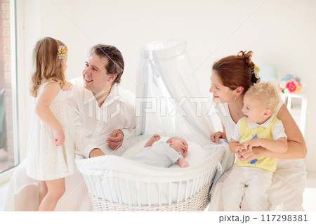 Family with kids playing with newborn baby Family with kids playing with newborn baby 117298381