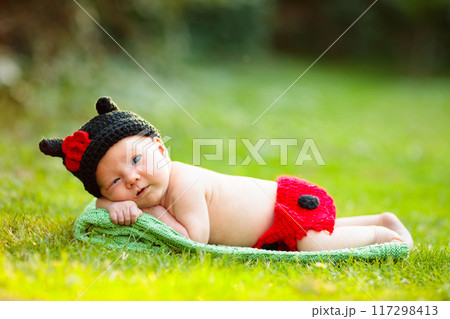 Baby in cute dress up costume. Newborn in garden. 117298413