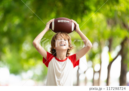 Family playing American football. Kids play rugby Family playing American football. Kids play rugby 117298724