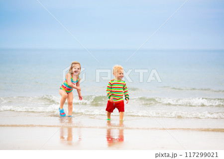Kids playing on beach. Children play at sea. Kids playing on beach. Children play at sea. 117299021
