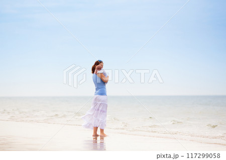 Mother and child on beach. Vacation with baby. 117299058