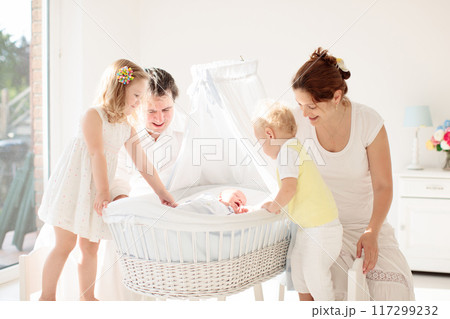 Family with kids playing with newborn baby 117299232