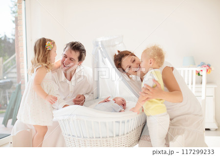 Family with kids playing with newborn baby 117299233