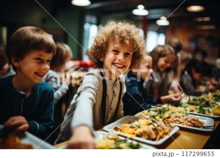 A schoolchild in the school cafeteria. Time of lunch break, peculiarities of the school meal, snack A schoolchild in the school cafeteria. Time of lunch break, peculiarities of the school meal, snack 117299655