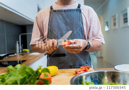 Chef at the kitchen preparing spicy glass noodle salad Chef at the kitchen preparing spicy glass noodle salad 117300345