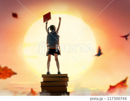 child on the tower of books 117300748