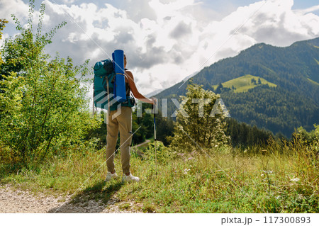 An Adventurous Hiker Truly Enjoys the Breathtaking Scenic Mountain Views and Surroundings An Adventurous Hiker Truly Enjoys the Breathtaking Scenic Mountain Views and Surroundings 117300893