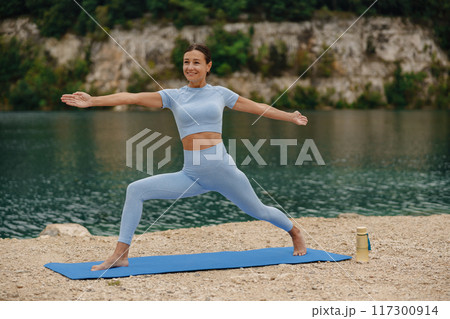 Engaging in a Peaceful Outdoor Yoga Practice by the Water for relaxation and rejuvenation Engaging in a Peaceful Outdoor Yoga Practice by the Water for relaxation and rejuvenation 117300914