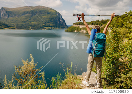 Embarking on a Hiking Adventure by the Beautiful Scenic Lake and Majestic Mountains 117300920