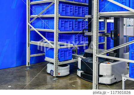 Autonomous Robot transportation in warehouses automation. Robots in storage hangar. AGV for moving racks, Warehouse automation concept. Autonomous Robot transportation in warehouses automation. Robots in storage hangar. AGV for moving racks, Warehouse automation concept. 117301026