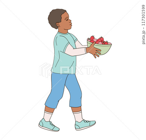 African American boy walks with a bowl of strawberries in his hands African American boy walks with a bowl of strawberries in his hands 117301599