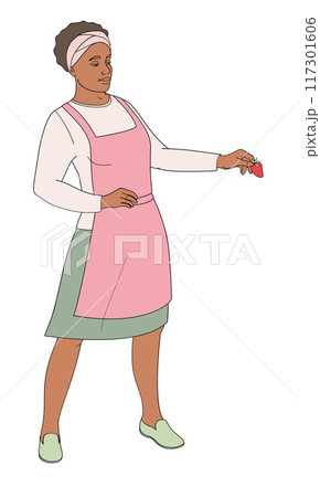 standing African American woman in an apron with strawberries in hand 117301606