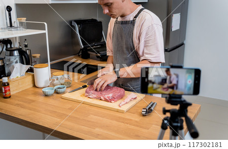 The chef is broadcasting live from workshop how to prepare a beef steaks on the electric grill The chef is broadcasting live from workshop how to prepare a beef steaks on the electric grill 117302181