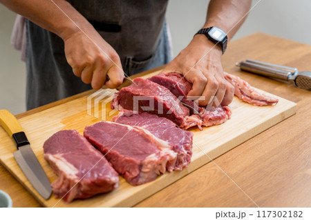 Raw fillet beef meat for steaks on the home electric grill 117302182