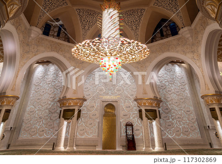 Stunning golden chandelier inside the Sheikh Zayed Grand Mosque in Abu Dhabi, showcasing exquisite Islamic architecture. Stunning golden chandelier inside the Sheikh Zayed Grand Mosque in Abu Dhabi, showcasing exquisite Islamic architecture. 117302869