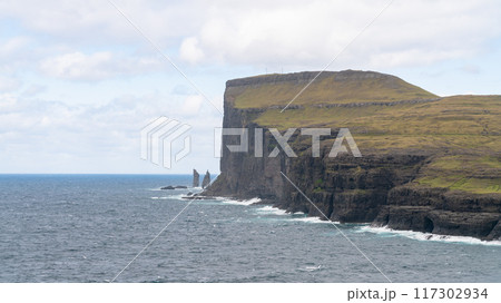 Risin and Kellingin sea rocks off the coast of the Faroe Islands. Risin and Kellingin sea rocks off the coast of the Faroe Islands. 117302934