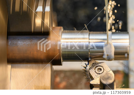 The lathe machine finish cut  metal shaft parts with liquid coolant method. 117303959