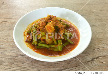 spicy stir fried slice yard long bean with fat pork and lemon grass in curry sauce on plate spicy stir fried slice yard long bean with fat pork and lemon grass in curry sauce on plate 117304086