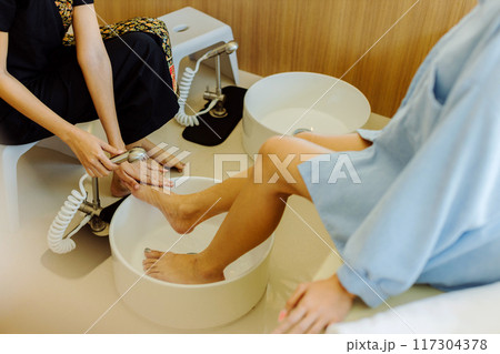 Relaxing with foot spa at beauty spa. Foot massage Relaxing with foot spa at beauty spa. Foot massage 117304378