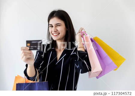 Beautiful girl holding shopping bags Beautiful girl holding shopping bags 117304572